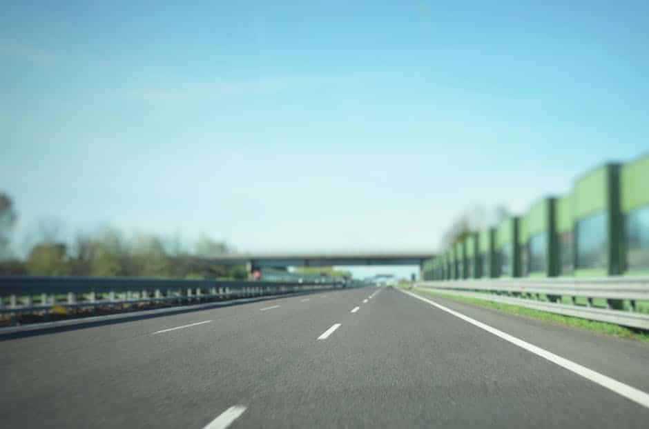 A Tesla car driving on a highway, demonstrating the use of Autopilot features.