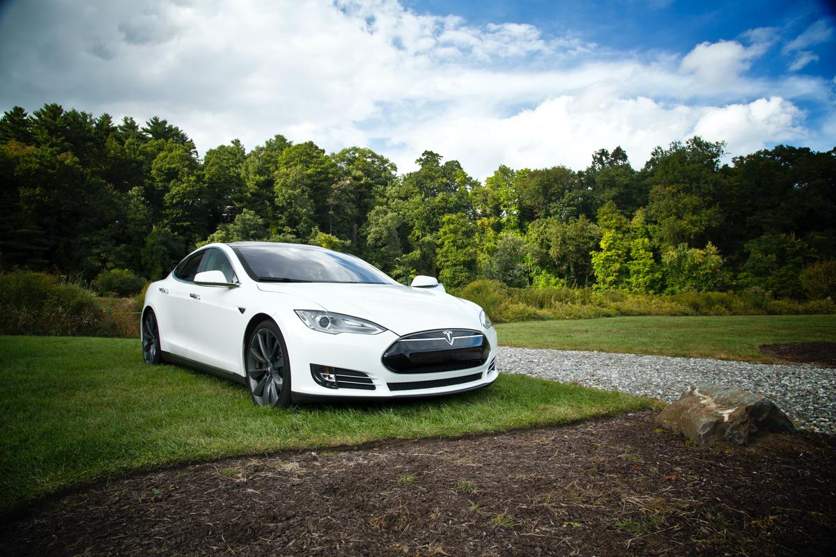 A Tesla Model S parked in front of a garage, highlighting the importance of maintenance for optimal performance.