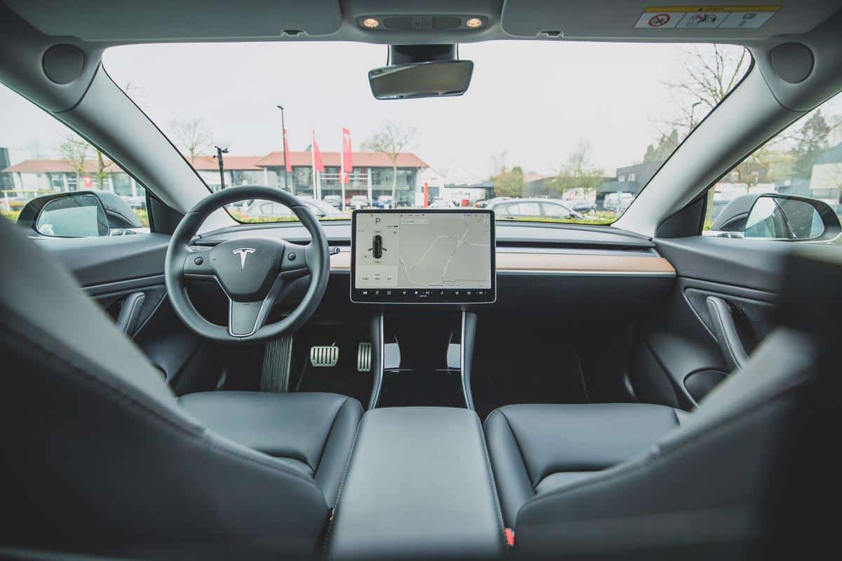 A computer screen showing the Pin to Drive feature on a Tesla car, illustrating the steps to set it up